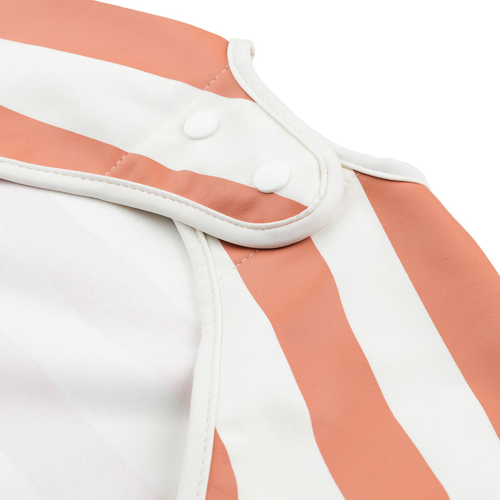 Done by Deer Waterproof bib with sleeves | Stripes papaya